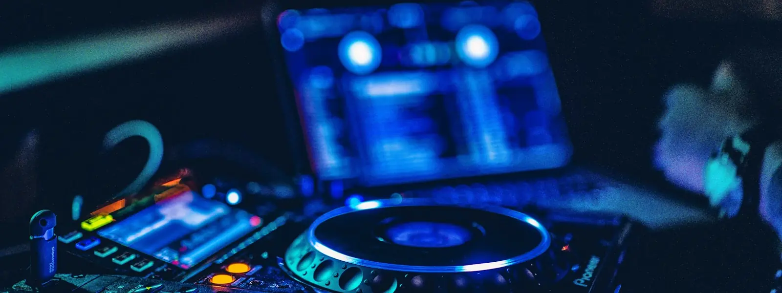 A lit DJ controller in a dark room